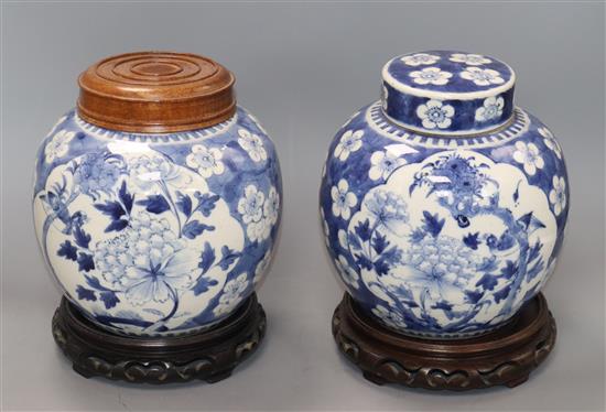 Two Chinese blue and white jars and covers and a pair of hardwood stands